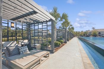 Infinity-edge olympic-size swimming pool with tanning deck & private cabanas